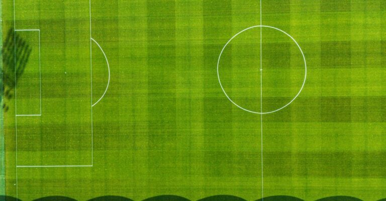Drone view of a green football field in Jönköping, Sweden, showcasing the pitch from above.