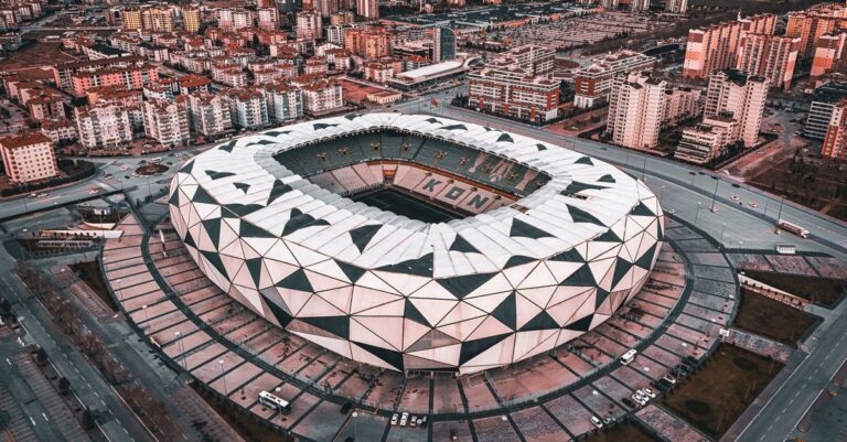 A stunning aerial view of the geometric design of Konya Stadium in Türkiye, showcasing urban architecture.