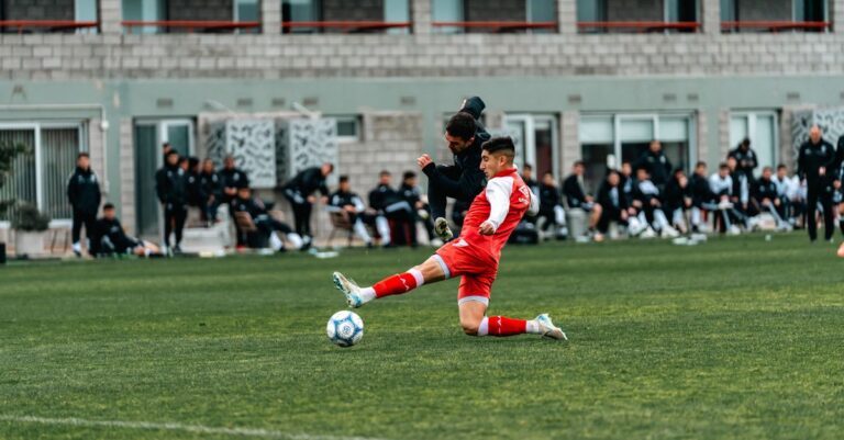 Exciting moment during a soccer match with players in action on a grassy field.